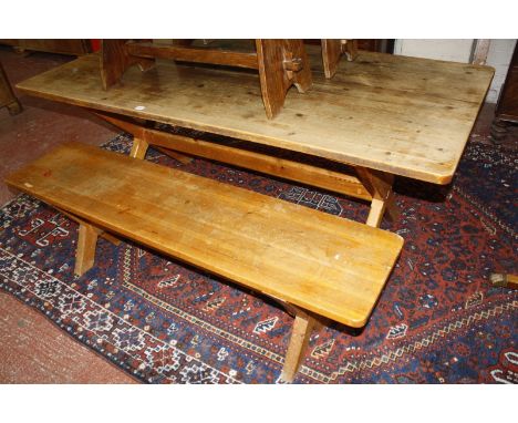 A pine trestle table on X-frame support 73cm high, 183cm, together with a pine bench
Purchased from the Conran Shop by the ve