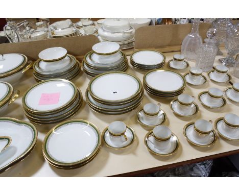 A Limoges part dinner and coffee service, green and gilt border, comprising tureens, soup bowls, plates, bowls and coffee can