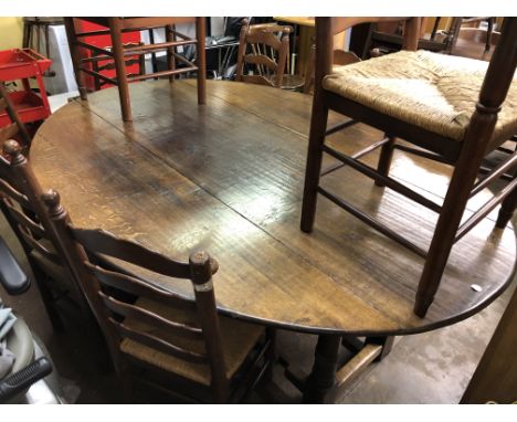 OAK OVAL DROP FLAP WEIGHT TABLE AND EIGHT RAFFIA SEATED LADDER BACK CHAIRS 