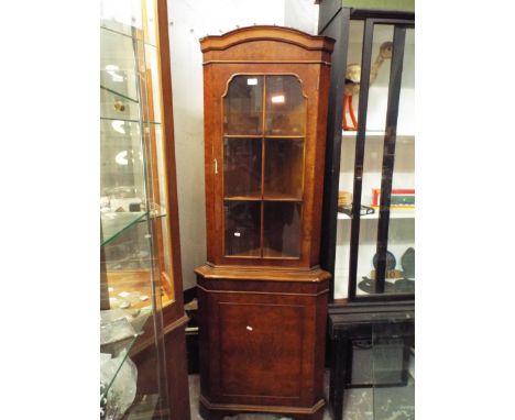 A burr walnut glazed corner cabinet with cupboard below