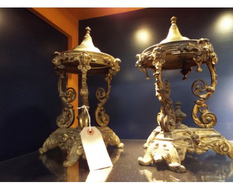 A pair of Neo-classical gilt brass garnitures, the conical tops above scrolling supports with applied female masks, raised on