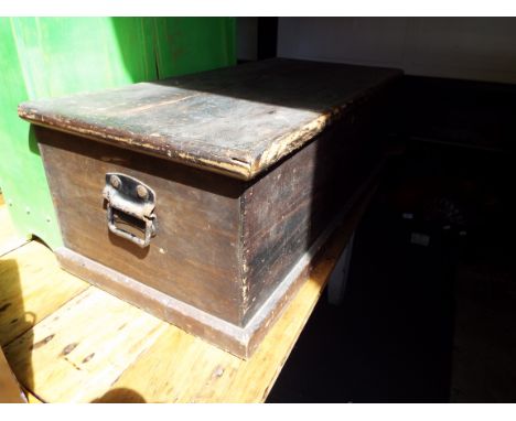 A stripped pine trunk with iron handles