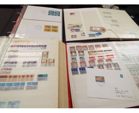 Four albums of Swiss stamps and first day covers