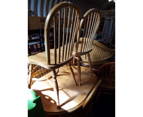 A pine extending oval kitchen table and a set of four stick-back chairs