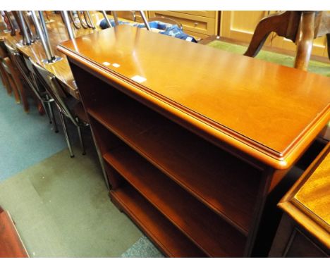 A mahogany two shelf bookcase raised on bracket feet