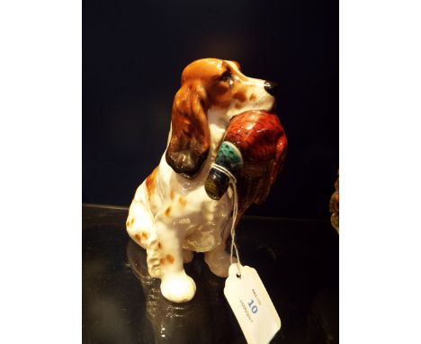 A Royal Doulton figurine of a Spaniel hunting dog with pheasant in his mouth, HN 1028