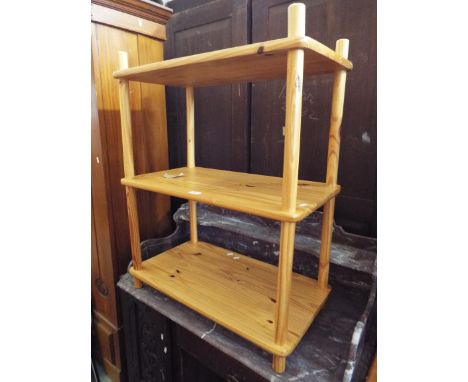 A pine three tier shelf unit