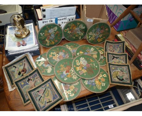 Quantity of old tablemats with pressed flowers under glass and tapestry squares.