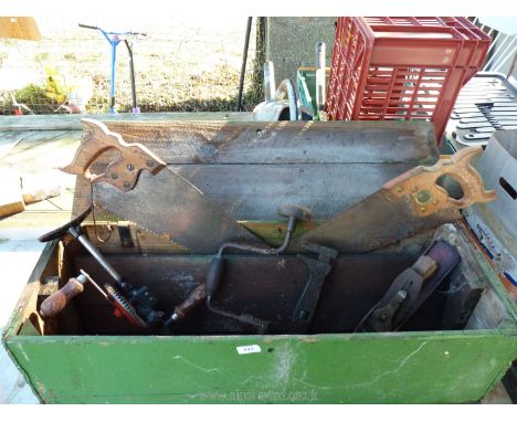 A wooden box of carpenter's tools - plane, grease gun, adjustable spanner etc.
