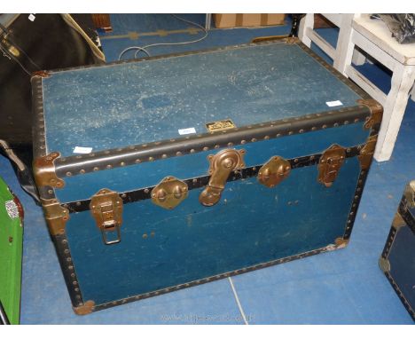 A navy 'Victor Wardrobe Luggage' trunk with fabric lining and shelf, 33 1/2'' x 19 1/2'' x 20'' high.