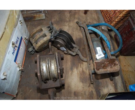 A vintage Dunlop foot pump and three rope pulley blocks.