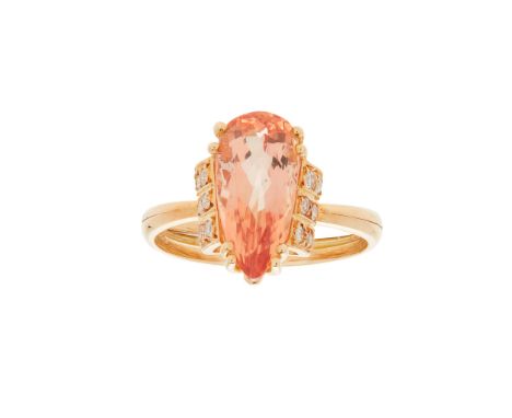 An imperial topaz and diamond set ring claw set with a pear-shaped imperial topaz, the shoulders each set with six eight-cut 