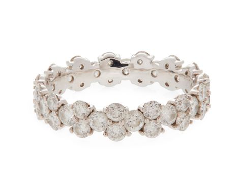 An 18ct white gold diamond set eternity ring claw set throughout with alternating pairs and single round brilliant-cut diamon