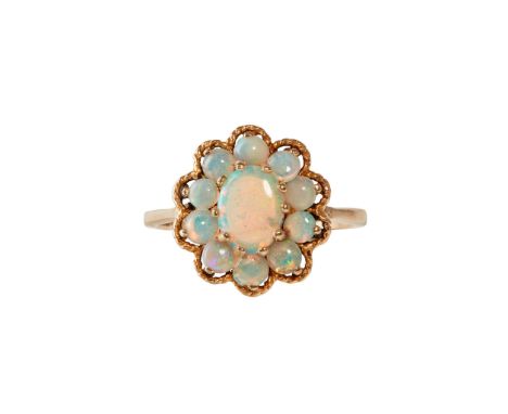 An opal set cluster ring claw set with an oval opal cabochon, in a border of round opal cabochons in a ropetwist border, to a