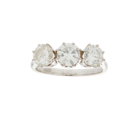 A three stone diamond set ring claw set with three round brilliant-cut diamonds, to a plain white metal shank stamped 18ct(Ri