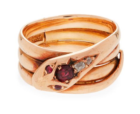 An Irish 18ct gold ruby and diamond set snake ring modelled as a coiled snake, the head claw set with a ruby and two old cush