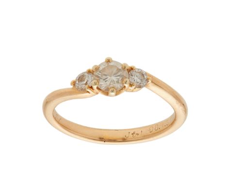 A three stone diamond ring claw set with three graduated round brilliant-cut diamonds, to a plain shank, stamped 18k; togethe