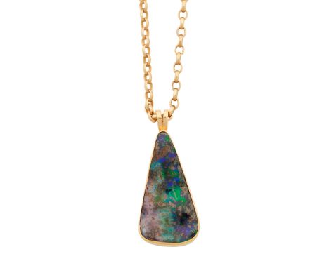 A contemporary opal set pendant the tapering boulder opal in a plain rub over setting, stamped 750 to the bale, with belcher 