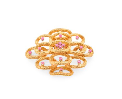 A modernist ruby set brooch composed of various tiers of open textured oval links, each claw set with a round-cut ruby, stamp