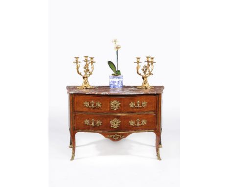 A Louis XV/XVI transitional tulipwood and kingwood serpentine commode, last quarter 18th century, the shaped marble top with 