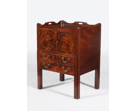 A George III mahogany tray top night commode, circa 1780, the rectangular top with a shaped gallery incorporating pierced car