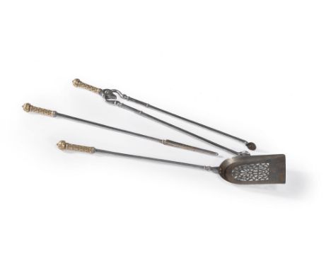 A set of Victorian brass mounted steel fire tools, mid 19th century, comprising shovel, poker and tongs, the handles cast wit