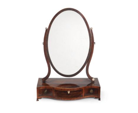 A George III mahogany serpentine fronted dressing mirror, circa 1790, of oversized proportions, the oval swing plate flanked 