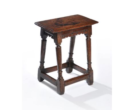 A Charles I oak joint stool, circa 1620, the solid seat with a moulded edge, above the moulded frieze incorporating pierced s