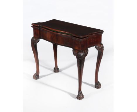 A George II mahogany folding card table, circa 1750, possibly Irish, the hinged shaped top opening to baize inset playing sur