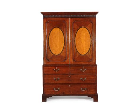 A George III mahogany and satinwood clothes press, circa 1790, the moulded and arcaded cornice above a pair of oval inlaid cu