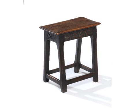 A oak joint stool, first half 17th century, the moulded rectangular top above a lunette carved frieze, on chamfered square se