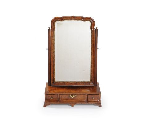 A George II walnut dressing mirror, circa 1735, the shaped mirror plate within a gilt gesso and moulded border, flanked by sq