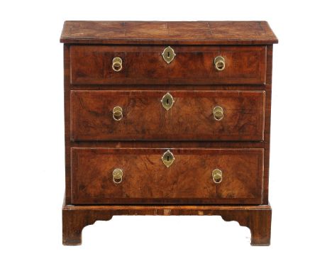 A George II walnut and featherbanded chest of drawers, circa 1735, of small proportions, the rectangular top with moulded edg