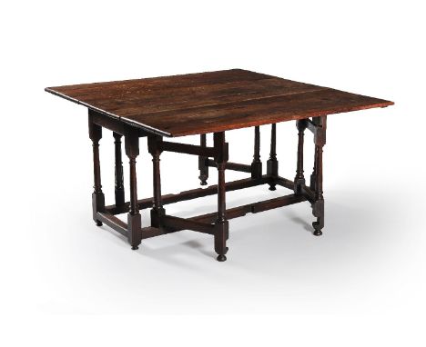 A William III oak gateleg dining table, circa 1700, the rectangular top incorporating twin hinged leaves, on square section a