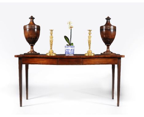 A George III mahogany serpentine serving table, circa 1790, the shaped top with crossbanded edge, above two blind frieze draw