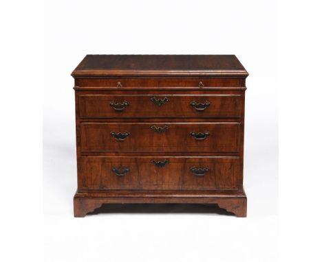 A George II walnut secretaire chest of drawers, circa 1740, the rectangular top with moulded edge above a shallow secretaire 