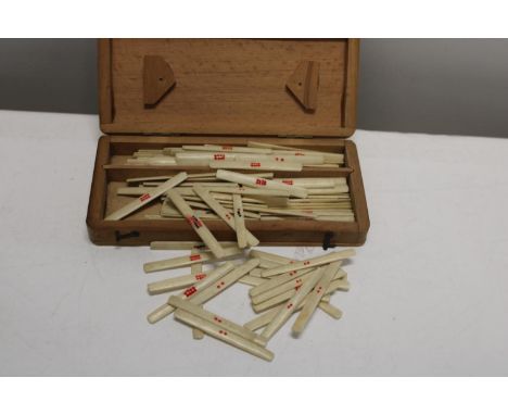 A box full of vintage ivory game markers 