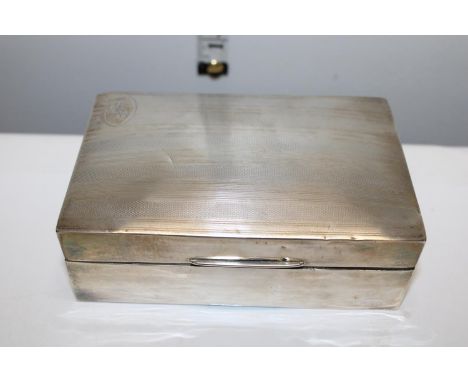 A silver cigarette box with engine turned decoration &amp; monogram to the lid. Hallmarked for Birmingham 1923. With a box wo