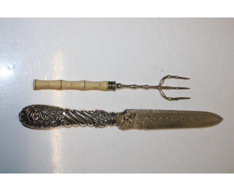 A hallmarked silver toasting fork with a bone handle hallmarked for Sheffield 1909. And a hallmarked silver handled bread kni