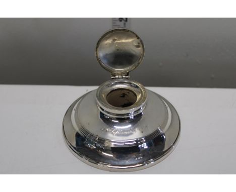 A loaded silver capstan inkwell hallmarked for Birmingham 1911. With inscription 
