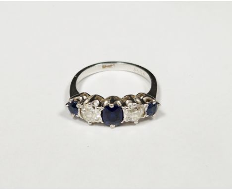 Sapphire and diamond five stone platinum ring, three oval mixed cut sapphires, the central sapphire measuring approx. 5.61 x 