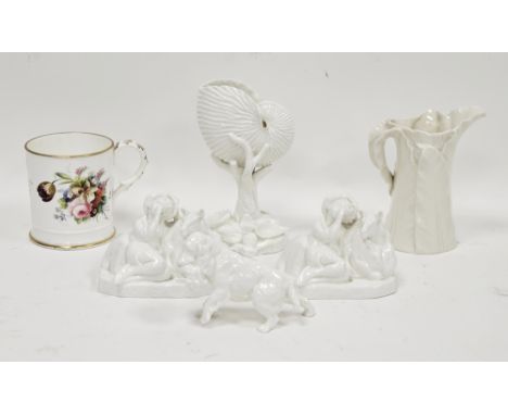 Royal Worcester white nautilus shell and coral vase, a leaf-moulded jug, two white glazed models of recumbent shepherd and sh