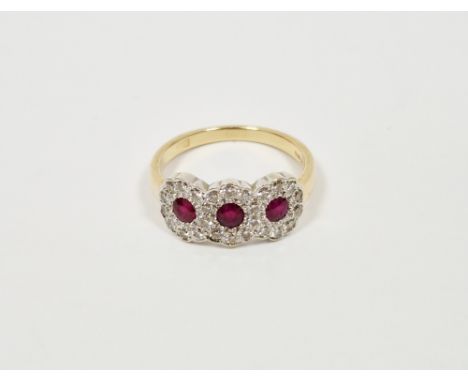 18ct gold, pink and white stone triple cluster ring set three pink stones, possibly rubies, surrounded by small diamonds (siz