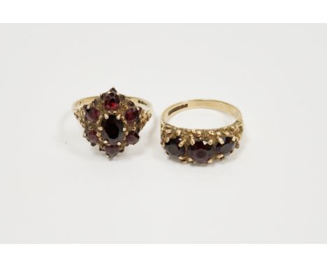 9ct yellow gold garnet cluster ring, claw set comprising a central oval mixed cut garnet surrounded by six further garnets, r