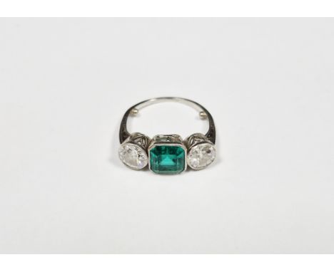 Early 20th century emerald and diamond white metal ring, the octagonal step cut emerald measuring approx. 6.8 x 6.5 x 4.2mm, 