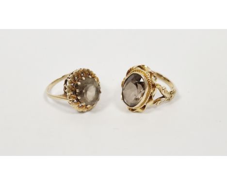 9ct gold smoky quartz ring, the oval cut stone in scroll mount (size P) and another gold and smoky quartz dress ring set oval