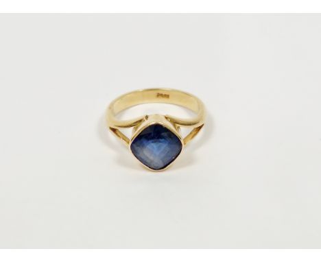 18ct gold and blue stone ring, the offset square cut stone in rubover setting, probably sapphire (size L1/2)&nbsp;Condition R