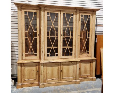 19th century pine breakfront library bookcase, the central section with a pair of astragal glazed doors opening to four adjus