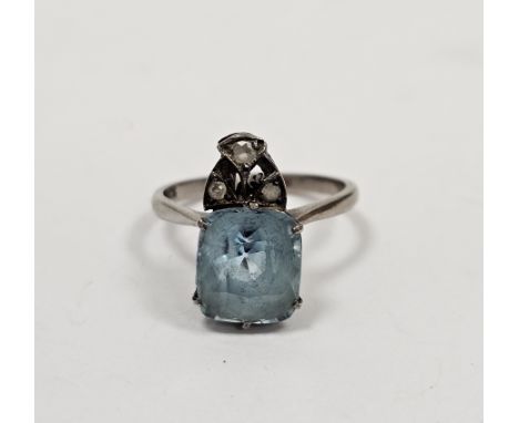 White metal and pale blue stone solitaire ring, the cushion shape stone topped by a trio of three tiny diamonds, ring size N