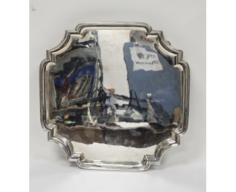 George V silver salver, Sheffield 1926, Mappin &amp; Webb, of square form with shaped canted corners, raised on four scroll f